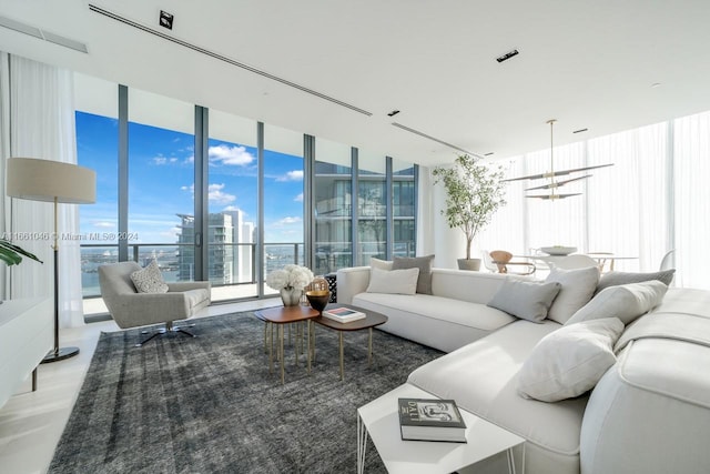 living room with an inviting chandelier and a wall of windows