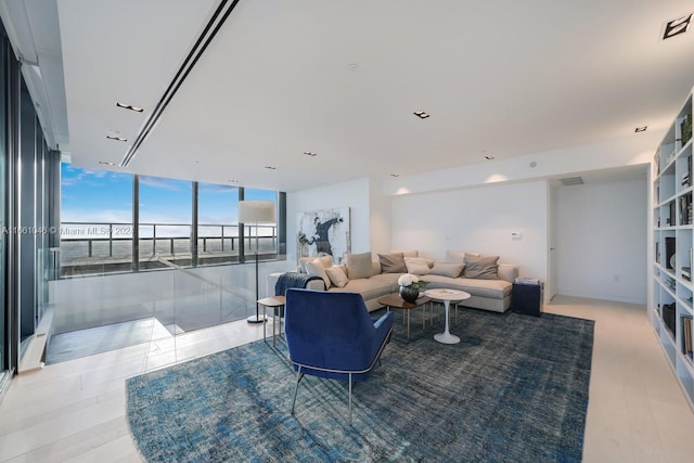 living room featuring floor to ceiling windows and hardwood / wood-style floors