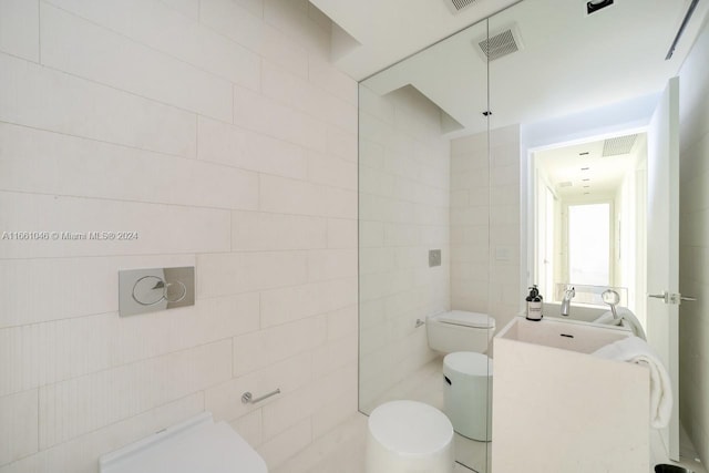 bathroom featuring tile walls, vanity, and toilet