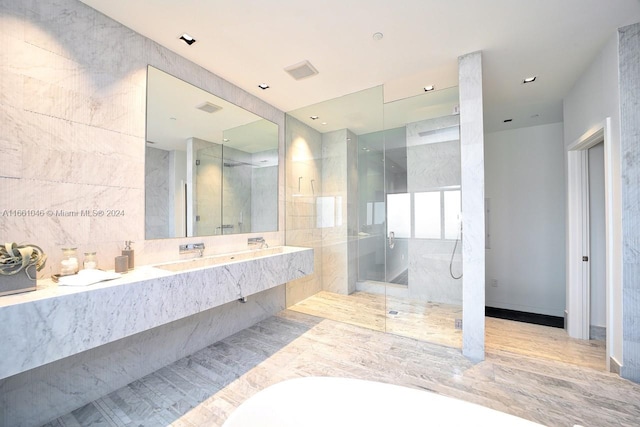 bathroom featuring tile walls, tile patterned flooring, vanity, and plus walk in shower