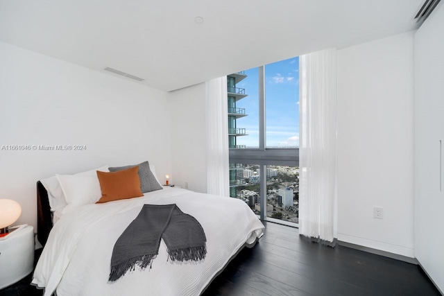 bedroom with dark wood-type flooring