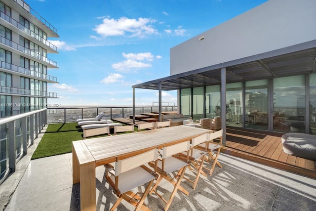 view of patio with a balcony and outdoor lounge area