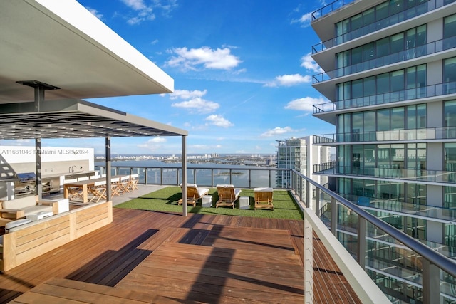 wooden terrace featuring a water view