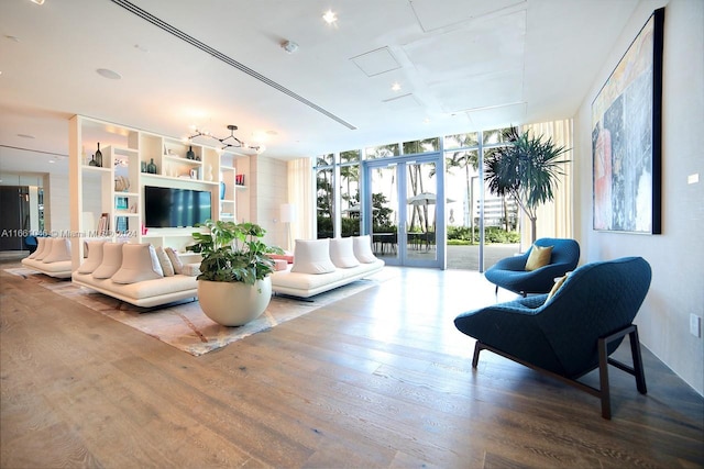 living room featuring a wall of windows and hardwood / wood-style flooring