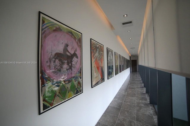 hallway with dark tile patterned flooring