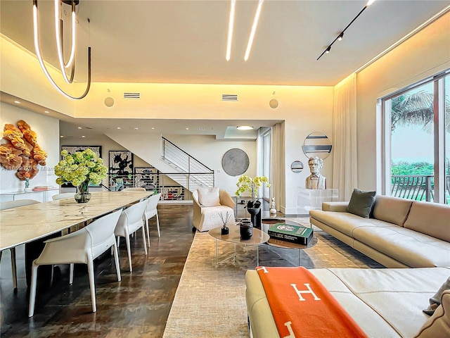 living room with dark hardwood / wood-style floors and rail lighting