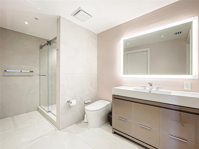 bathroom featuring tile patterned flooring, vanity, toilet, and a shower with shower door