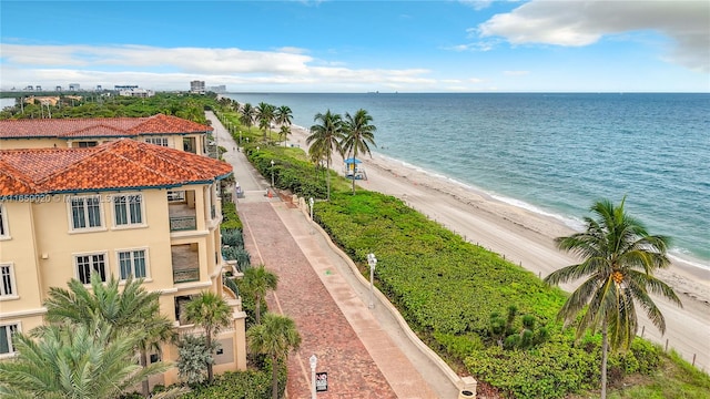 bird's eye view with a water view and a beach view