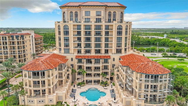 view of building exterior with a community pool