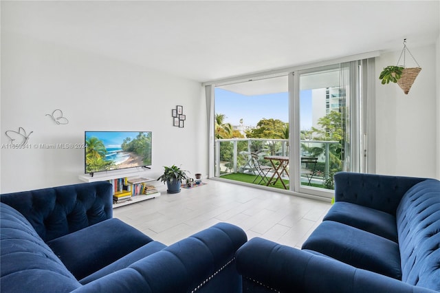 living room featuring a wall of windows and light hardwood / wood-style floors