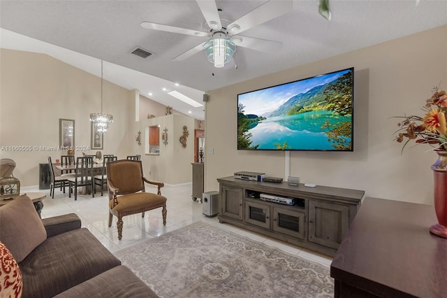 living room with light tile patterned floors, a textured ceiling, ceiling fan with notable chandelier, and vaulted ceiling