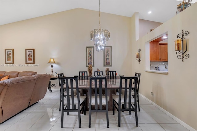 dining area with light tile patterned flooring, sink, a chandelier, and high vaulted ceiling