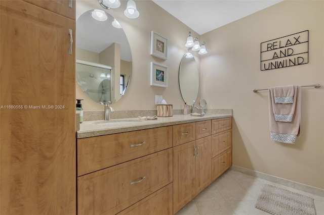 bathroom with tile patterned floors, a shower with shower door, and vanity