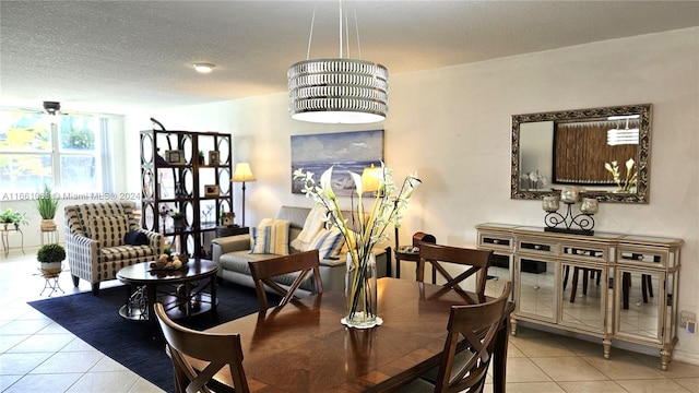 dining area with a textured ceiling and light tile patterned floors