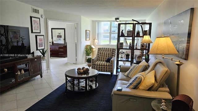 tiled living room featuring a textured ceiling