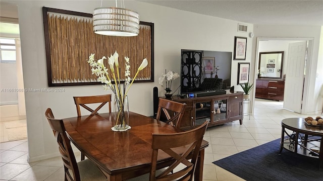 dining space featuring a textured ceiling and light tile patterned floors