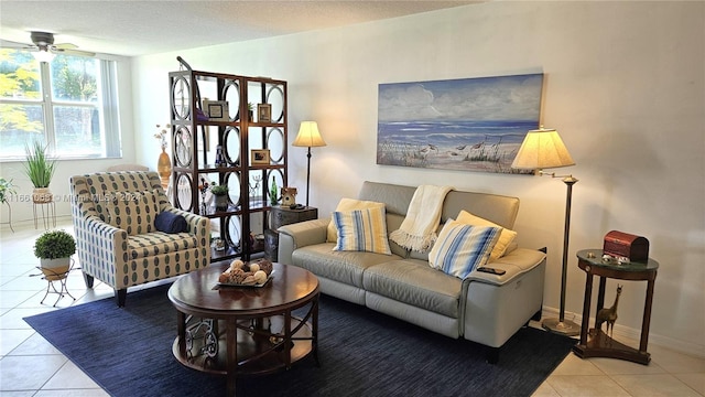 living room featuring a textured ceiling, light tile patterned flooring, and ceiling fan