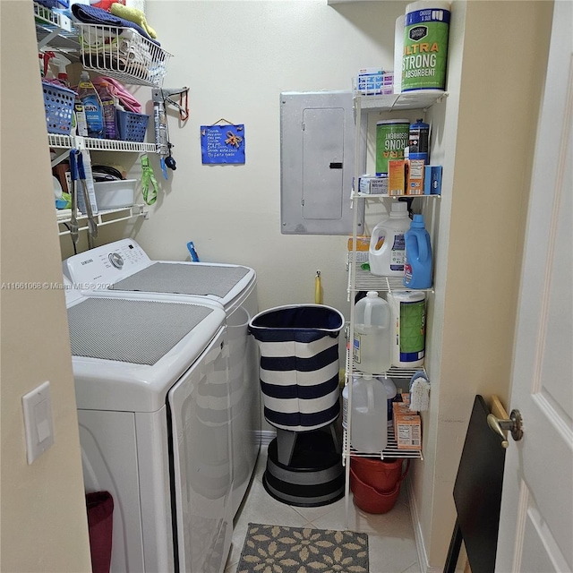 laundry area featuring electric panel, washing machine and dryer, and tile patterned floors