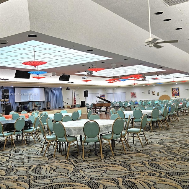 dining area with carpet and ceiling fan