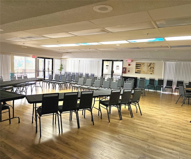 dining area featuring light hardwood / wood-style floors and a paneled ceiling