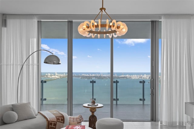 interior space with a water view, a chandelier, and plenty of natural light