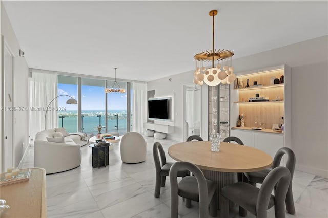 dining room featuring floor to ceiling windows and a chandelier