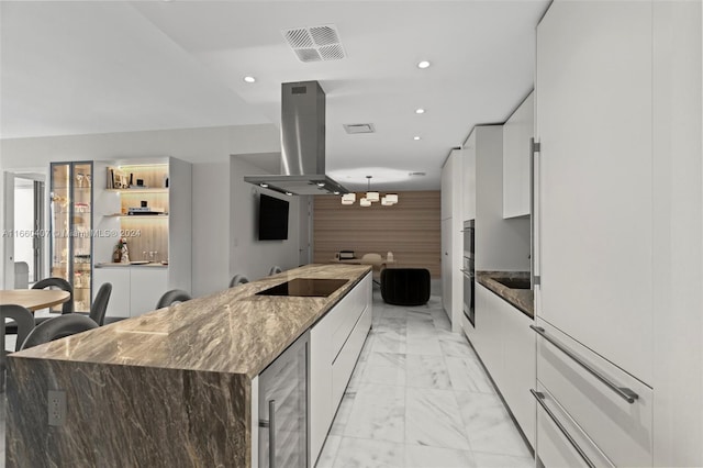 kitchen with a large island, white cabinetry, island exhaust hood, and wine cooler