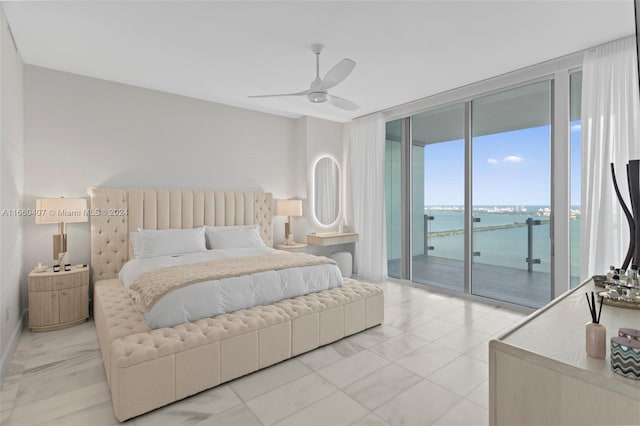 bedroom with a water view, floor to ceiling windows, ceiling fan, and access to exterior