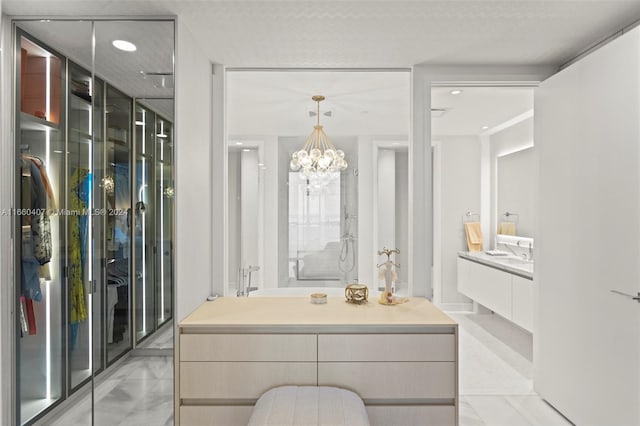 bathroom featuring an inviting chandelier and vanity