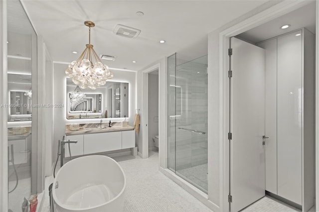 full bathroom featuring tile patterned flooring, a chandelier, separate shower and tub, vanity, and toilet