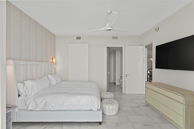 bedroom featuring ceiling fan and ensuite bath