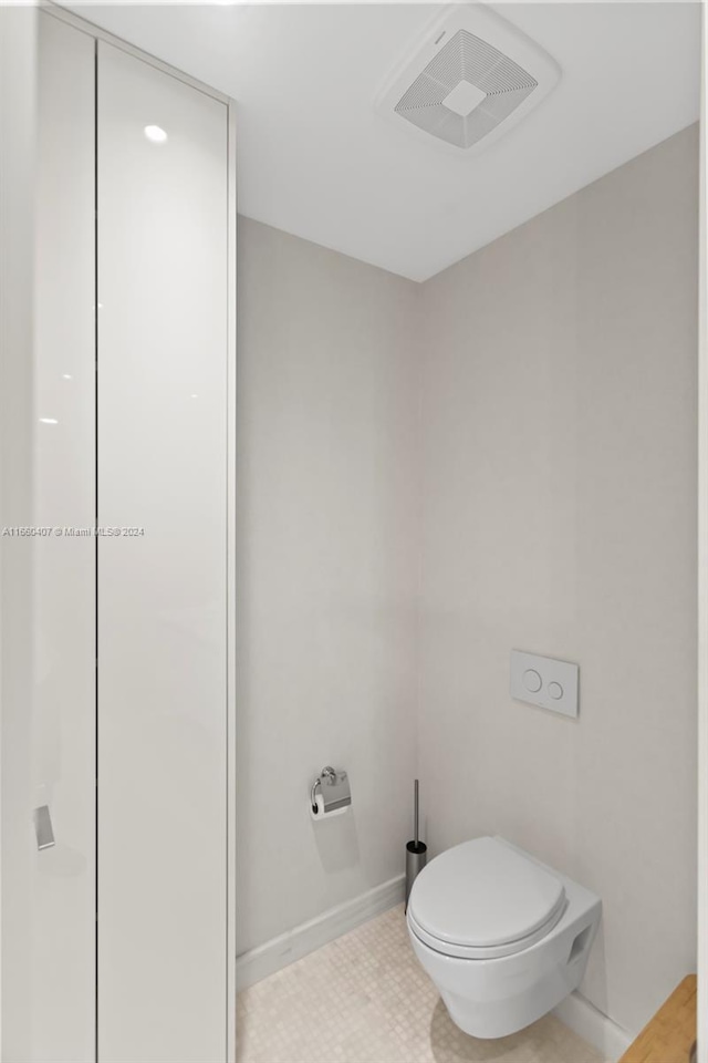 bathroom featuring tile patterned flooring and toilet