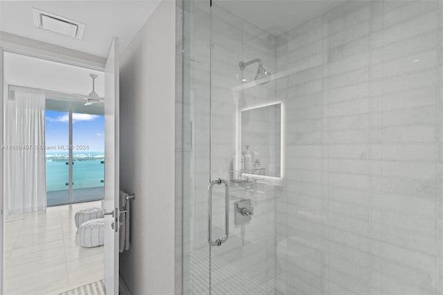 bathroom with walk in shower and a water view