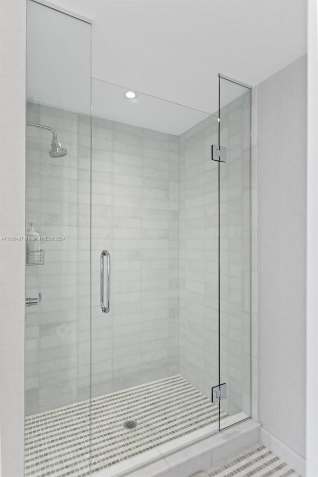 bathroom with a shower with door