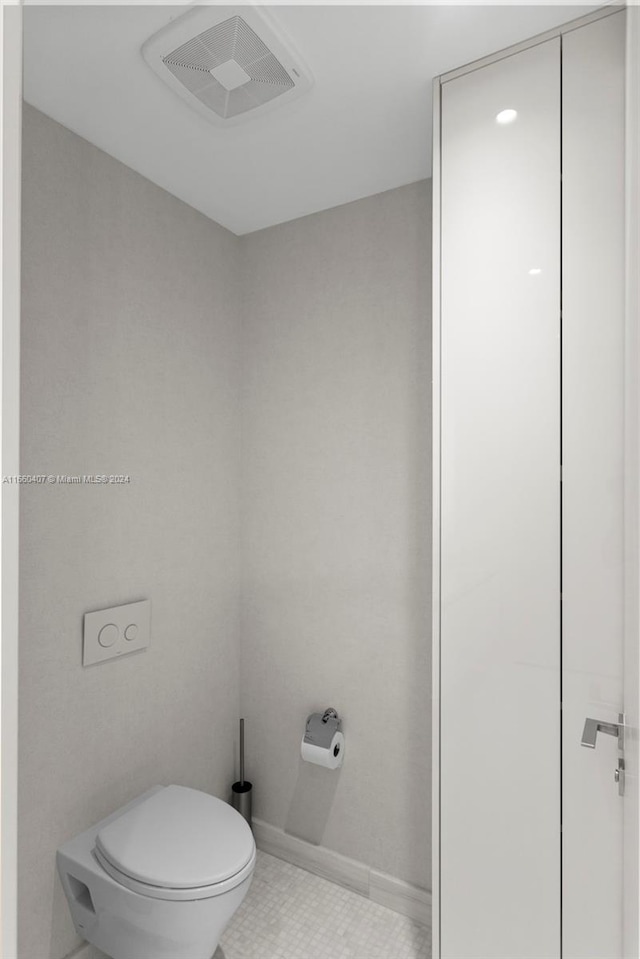 bathroom featuring toilet and tile patterned floors