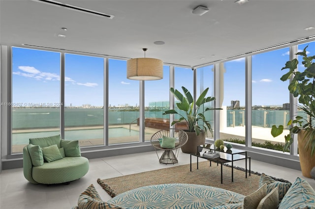 sunroom / solarium featuring a water view and plenty of natural light