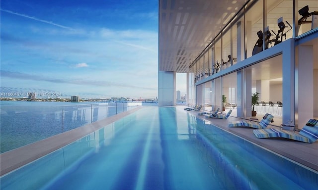 view of swimming pool with a water view