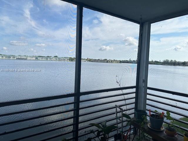 view of dock with a water view and a balcony