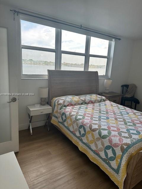 bedroom featuring hardwood / wood-style floors and multiple windows