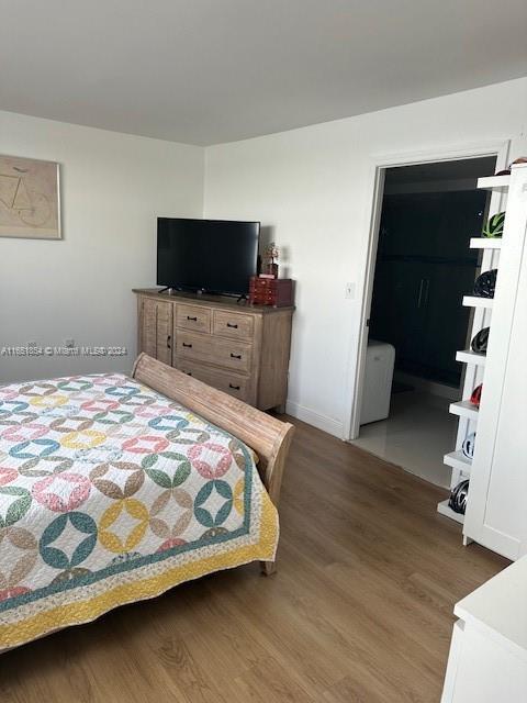 bedroom with dark hardwood / wood-style flooring