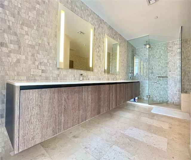 bathroom featuring tile walls, vanity, and a shower with shower door