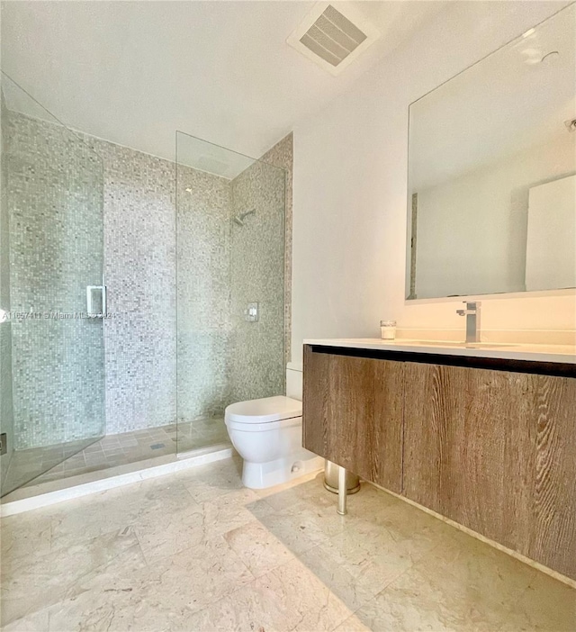 bathroom with vanity, toilet, and an enclosed shower