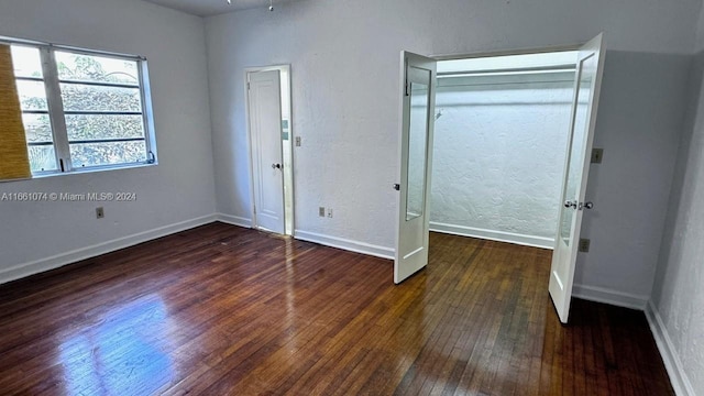 unfurnished bedroom featuring dark hardwood / wood-style floors