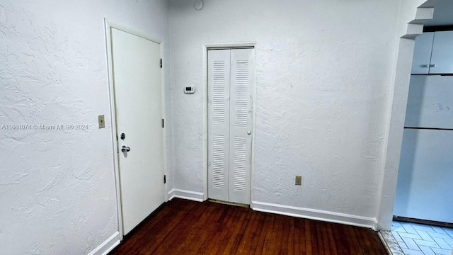 interior space with baseboards and wood finished floors