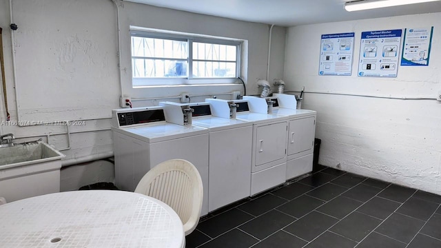 clothes washing area featuring sink and independent washer and dryer