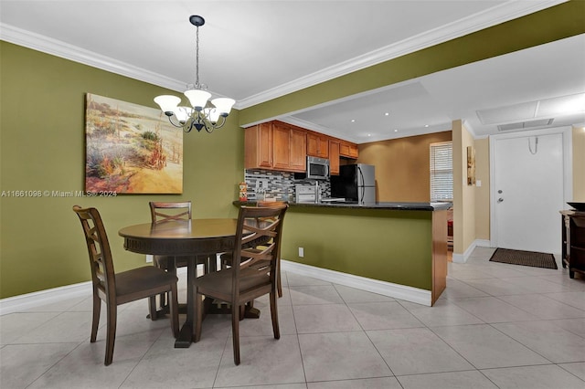 tiled dining area with crown molding and a chandelier