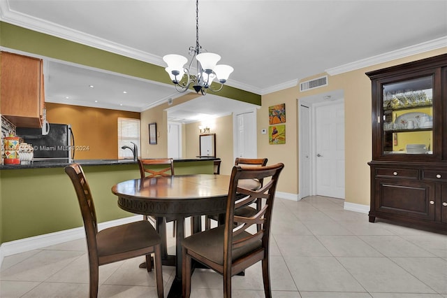 tiled dining room featuring ornamental molding, a notable chandelier, and sink