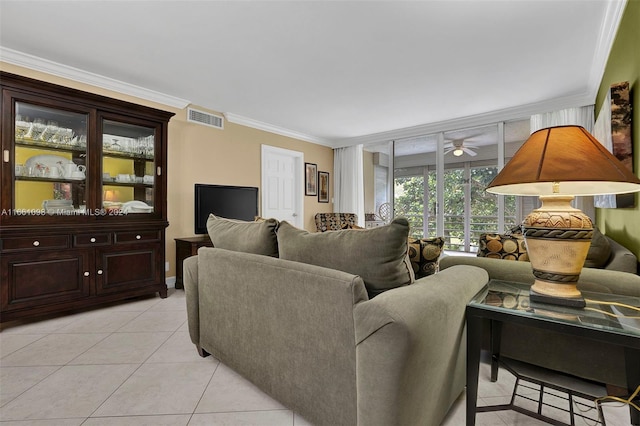 living room featuring ceiling fan, light tile patterned floors, and crown molding