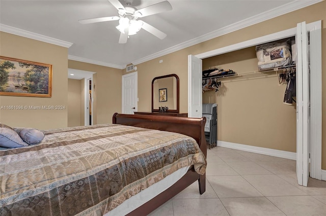 tiled bedroom featuring crown molding, ceiling fan, and a closet