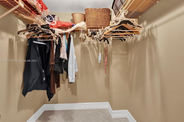 walk in closet with tile patterned flooring